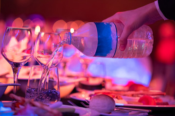 close up waiter is serving water