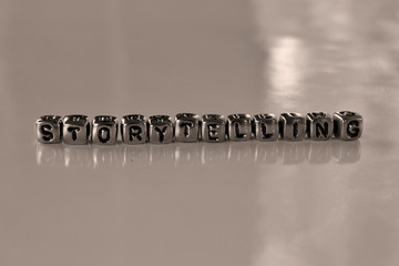 Storytelling or story telling  -  word from metal blocks - concept sepia tone photo on shine...