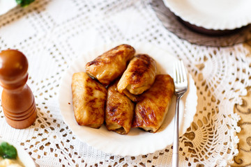 fried cabbage rolls on a white plate on the table