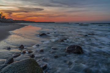 Fototapeta na wymiar rocky sea beach at colorful sunset