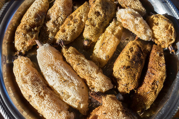 The honeycomb, which has the larvae inside, is used as a dessert for Burmese people.
