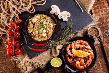 Fried large shrimp in tomato sauce with olive oil,Mushrooms in cream sauce, julienne, champignon, products for cooking