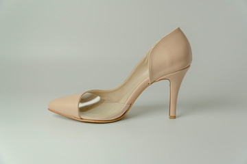 women's heeled shoes, flat sole sports shoes, patent leather shoes on a white background