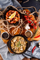 Fried large shrimp in tomato sauce with olive oil,Mushrooms in cream sauce, julienne, champignon, products for cooking