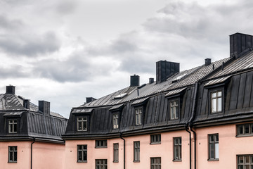 Fototapeta na wymiar Pastel colored buildings with black roofs