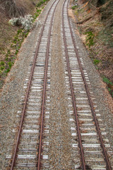 Fototapeta premium Steel train tracks heading toward town