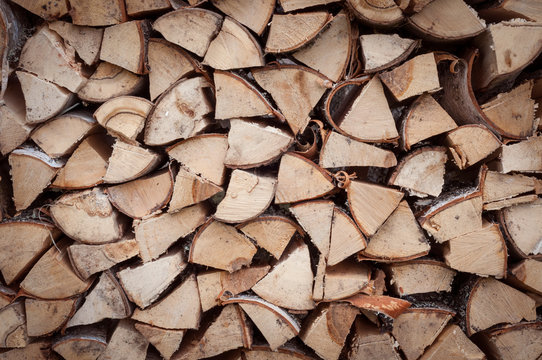 the woodpile of harvested stacked chopped firewood