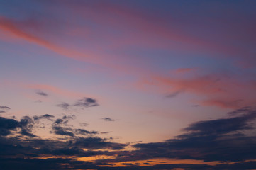Colorful sunset sky over the horizon. Layered clouds.