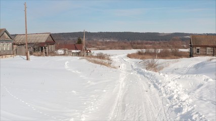 Russian road in the winter. Winter road in the village. Winter landscape in the village shot from a quadcopter