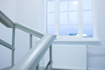 A white stairs up ladder in a new office building