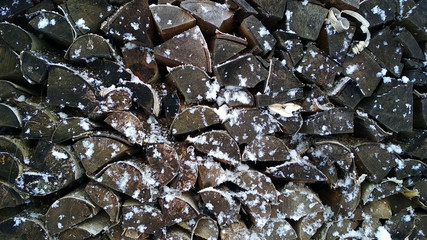 the pile of firewood in the snow