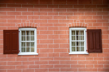 Fototapeta na wymiar Brick wall with white windows