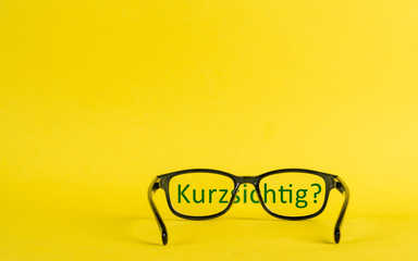 Concept about nearsightedness depicted with glasses and text