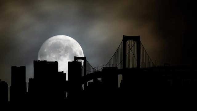 Tokyo: Time Lapse by Night with Full Moon, Rainbow Bridge and Skyscrapers in Silhouette, Japan