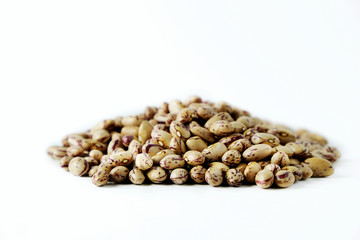 A handful of spotted brown kidney beans on a white background. Legumes are a source of protein. Place for text