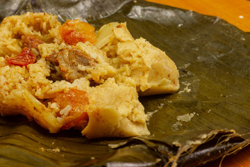 Nacatamal typical Nicaraguan food, corn, meat, butter, potatoes, onion, wrapped banana leaf
