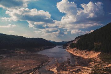 Landscape view of a river surrounded by forest and clouds