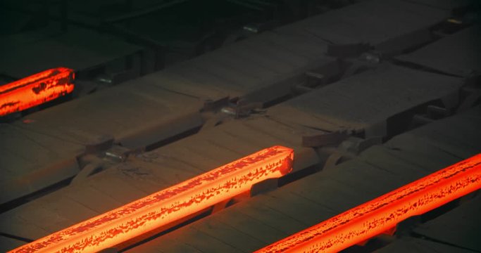 Iron foundry. Continuous casting machine. Steel billet moving through the pipeline.