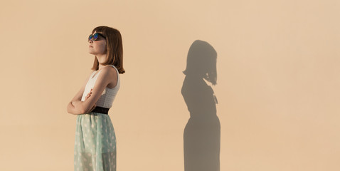 The girl and her shadow quarreled and turned away from each other.