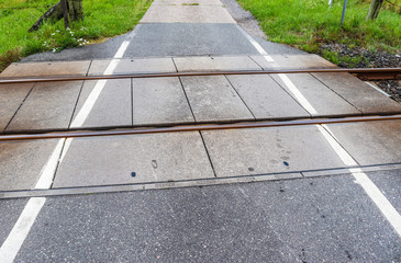 Railroad crossing at a country road on a summer day