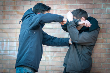 Bullying, violence and aggression scene, a boy punches his peer