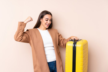 Traveler woman with suitcase celebrating a victory