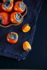 persimmons on black background