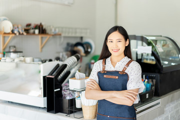 Happy Asian woman barista working, Successful small business owner standing with crossed arms preparing coffee, success to make sme business, professional occupation looking at camera in restaurant