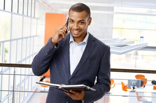 Afro american office worker with mobile phone
