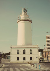 Malaga lighthouse seen from the dike of Levante, vintage