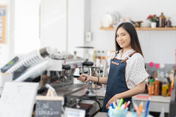 Fototapeta na wymiar Happy Asian woman barista working, Successful small business owner standing with crossed arms preparing coffee, success to make sme business, professional occupation looking at camera in restaurant