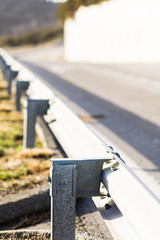 Metal barrier fence on the edge of a highway