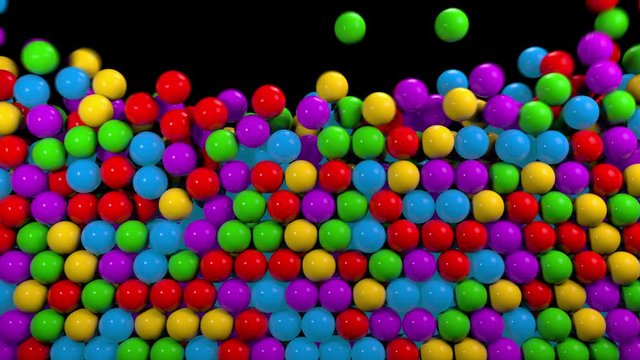 Colorful glossy balls falling from top. Kids plastic shiny toys, abstract motion background
