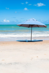 blue umbrella against a blue sky gradient