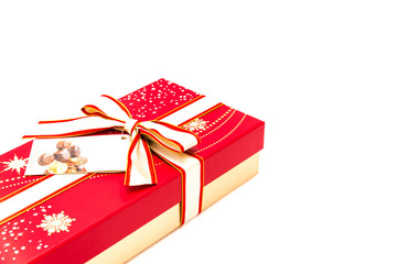 Red chocolate box with tag label and red yellow bow ribbon isolated on white