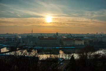prague tv tower at sunrise wirh roofs and birds flying