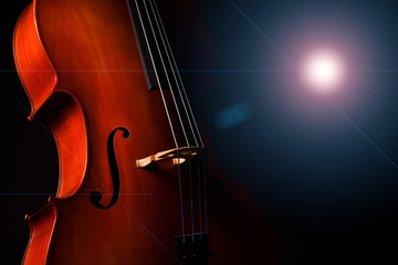 Cello isolated on black background with blue spotlight