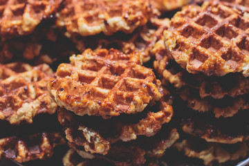 Fresh belgian stroopwafels waffles with caramel and chocolate, street food on traditional Christmas...