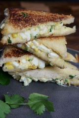 A stack of Bread and egg salad with mayonaise sandwich on a plate with copy space.