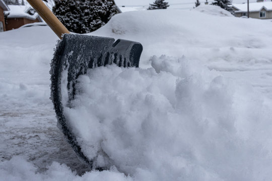 Clearing Driveway Snow with a Shovel