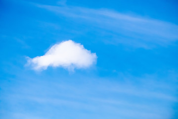 Naklejka na ściany i meble A Puffy Cloud in a Hazy Blue Sky