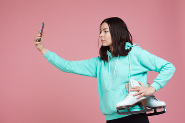 Figure skating, Hobbies and a healthy active lifestyle. A cheerful girl in a bright hoodie with...