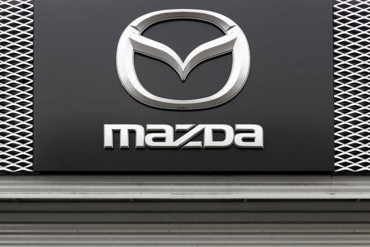 Macon, France - May 27, 2018: Mazda logo on a facade. Mazda is a Japanese automaker based in Fuchu, Japan