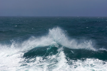 waves crashing on the open sea, stormy weather