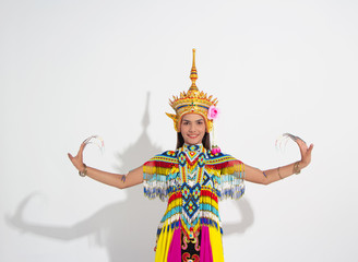 Fototapeta premium Young lady wearing Thai Tradition southern costume and put headdress on her head,showing basic pattern folk dance,black shadow reflection on white background