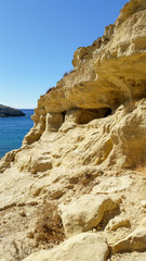 Fototapeta na wymiar Matala beach. Caves on the rocks were used as a roman cemetery and at the decade of 70's were living hippies from all over the world, Crete, Greece