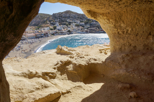 Panorama of Matala beach and caves on the rocks, Crete, Greece