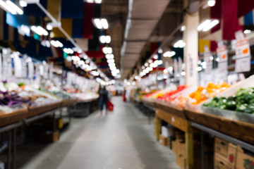 Blurred image of fresh farmers market sell variety of organic fruits and vegetables.