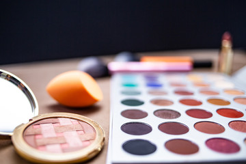 Obraz na płótnie Canvas Makeup studio with all the accessories such as shadow palettes, concealers, makeups, eyeliners, brushes, lipstick and highlighter