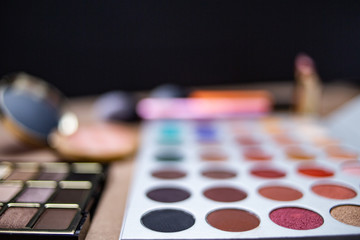 Fototapeta premium Makeup studio with all the accessories such as shadow palettes, concealers, makeups, eyeliners, brushes, lipstick and highlighter